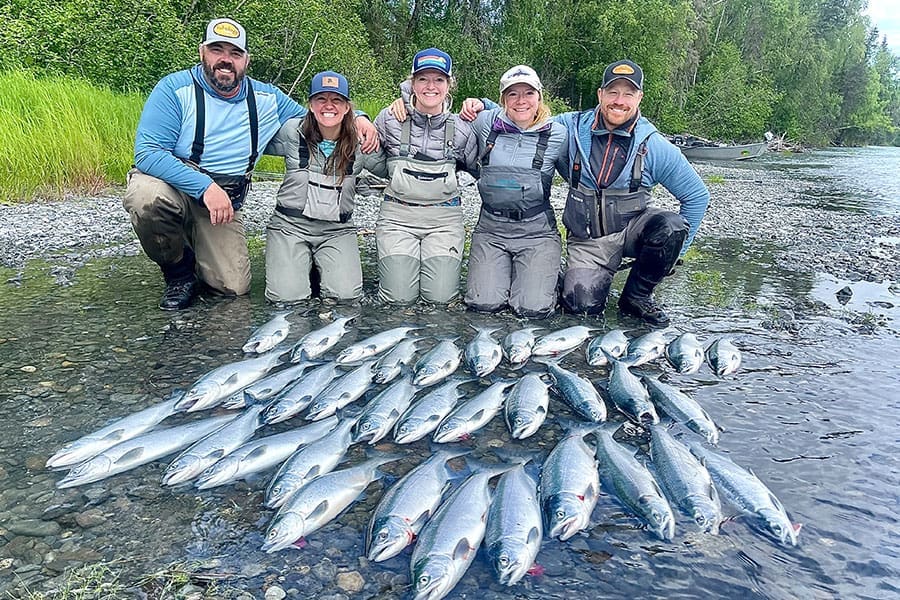 Fishology fishing guide instructing a family on the Kenai River