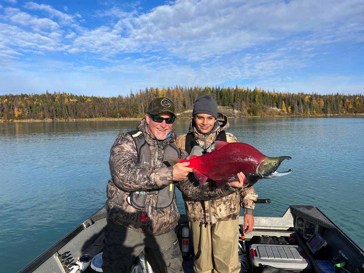 Trophy Drifters guest landing rainbow trout in the Kenai River